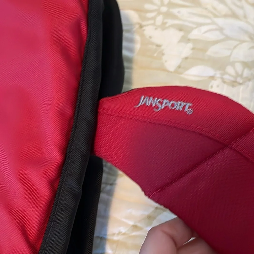 Red Jansport laptop messenger bag. Interior Velcro & outer zippered compartment